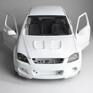 A car body with windows, doors, and headlights but no wheels