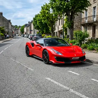 A bright red sports car parked on a gray asphalt road — the 
