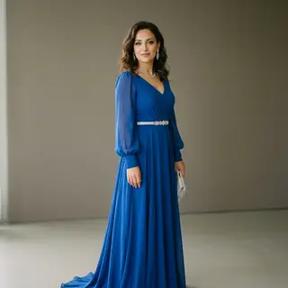 A woman wearing a royal blue evening dress against a neutral