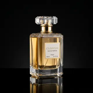A clear glass perfume bottle on a reflective black surface w