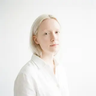 A high-key portrait of a person against a bright white backg