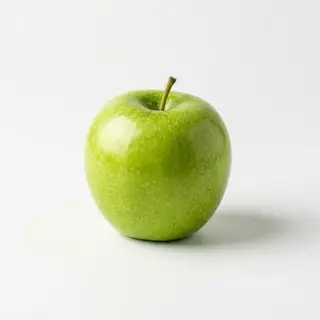 A ripe green apple on a seamless white background with soft 