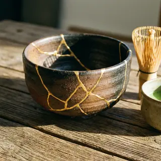 A Japanese kintsugi bowl — cracked ceramic repaired with vis