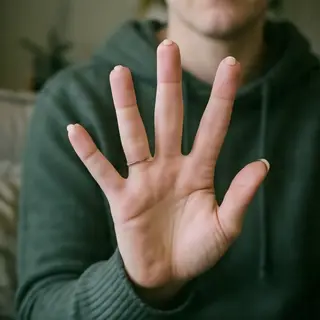A person counting to three on their fingers, with index, mid