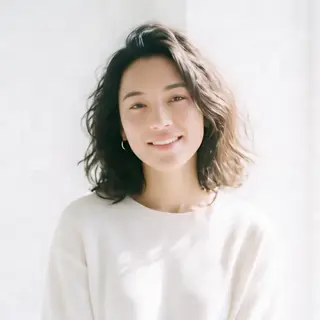 A high-key portrait of a person against a bright white backg