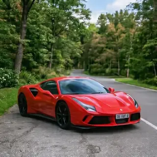A bright red sports car parked on a gray asphalt road — the 