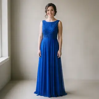 A woman wearing a royal blue evening dress against a neutral