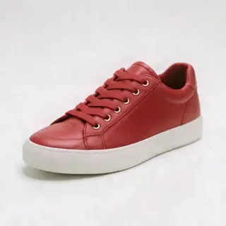 A single red sneaker on a clean white background with soft s