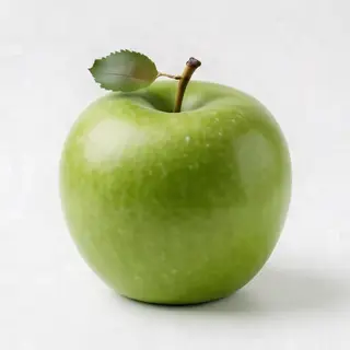 A ripe green apple on a seamless white background with soft 