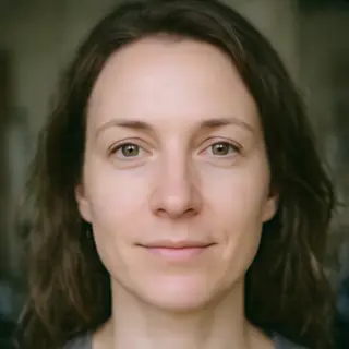 A human face with eyes, nose, and mouth but no eyebrows