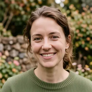 A close-up portrait of a young woman with a warm natural smi
