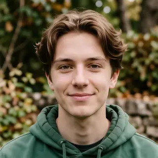 A headshot of a teenager with a relaxed, neutral face