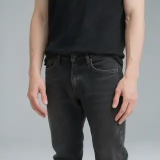 A person standing with both hands visible at their sides, fi