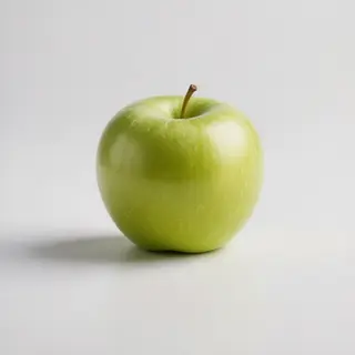 A ripe green apple on a seamless white background with soft 