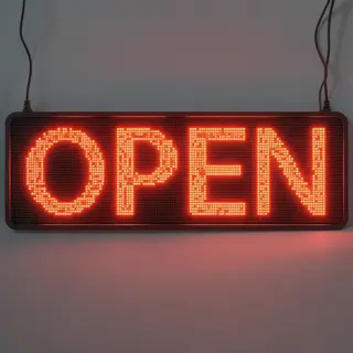 The word 'OPEN' displayed on a red LED sign with glowing pix
