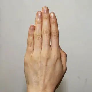 A person counting to three on their fingers, with index, mid