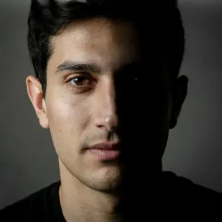 A portrait with dramatic split lighting — half the face brig