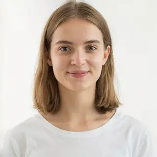 A high-key portrait of a person against a bright white backg