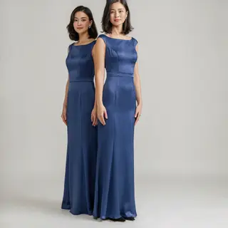 A woman wearing a royal blue evening dress against a neutral