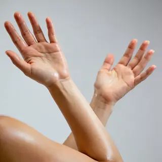 A woman holding her hands out in front of her palms-up, all 