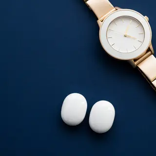A product flat-lay on a #1A1A2E (deep dark blue) background,