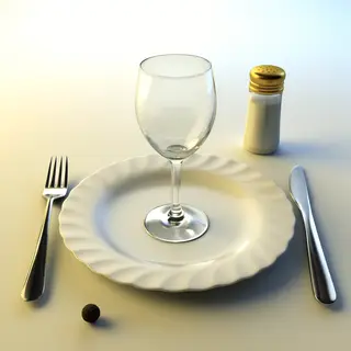 A dinner table scene with a plate, fork, knife, wine glass, 