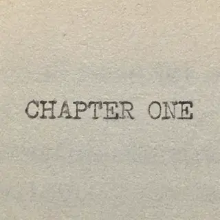 The word 'CHAPTER ONE' typed on aged paper with a vintage ty
