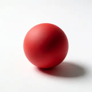 A red sphere on a white surface with a single shadow cast to