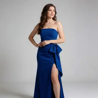 A woman wearing a royal blue evening dress against a neutral