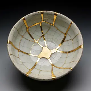 A Japanese kintsugi bowl — cracked ceramic repaired with vis