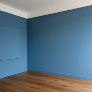 A room with walls in #4A90D9 (medium blue) with warm wooden 