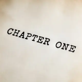 The word 'CHAPTER ONE' typed on aged paper with a vintage ty