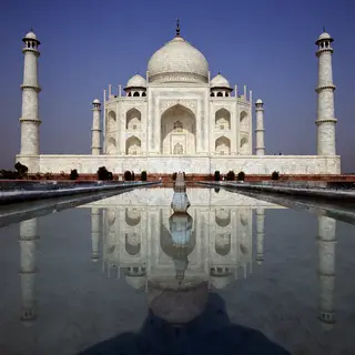 The Taj Mahal in Agra seen from the reflecting pool, with ac