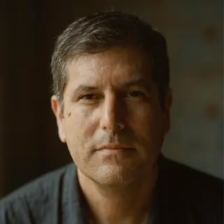 A portrait of a middle-aged man with a calm, serious express