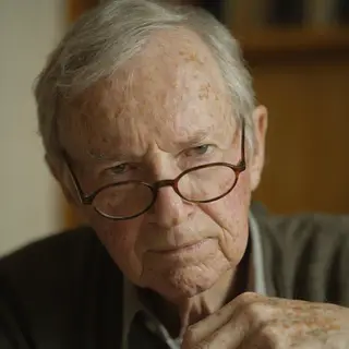 An elderly man in his 70s with age spots and thinning gray h