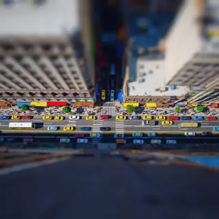 A tilt-shift photograph of a city street making real-life lo