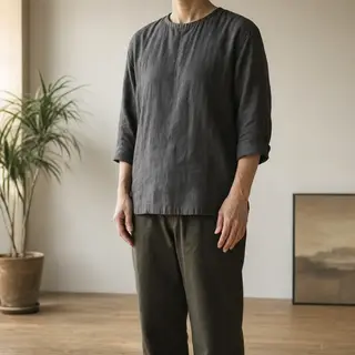 A person standing with both hands visible at their sides, fi