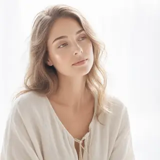 A high-key portrait of a person against a bright white backg