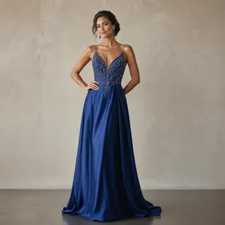 A woman wearing a royal blue evening dress against a neutral