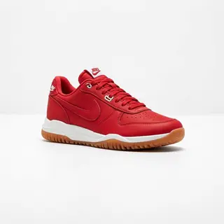 A single red sneaker on a clean white background with soft s