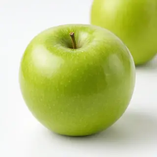 A ripe green apple on a seamless white background with soft 