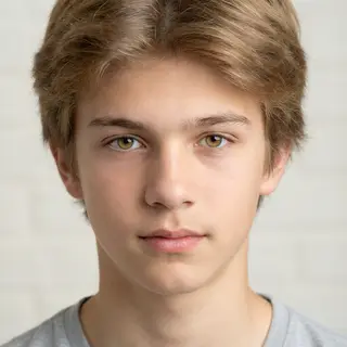 A headshot of a teenager with a relaxed, neutral face