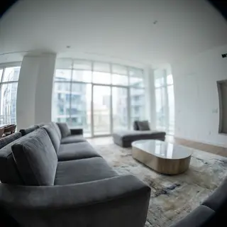 A wide-angle shot of a modern living room interior showing e