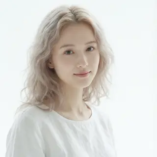 A high-key portrait of a person against a bright white backg