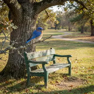 A bird perched on a branch, the branch extending from a tree