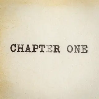 The word 'CHAPTER ONE' typed on aged paper with a vintage ty