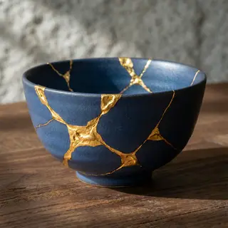 A Japanese kintsugi bowl — cracked ceramic repaired with vis