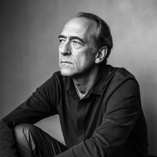 A portrait of a middle-aged man with a calm, serious express
