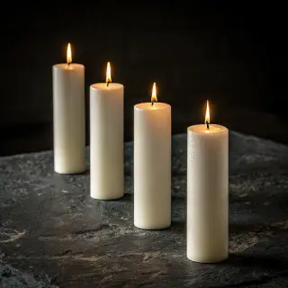 Exactly 4 white candles standing on a dark surface