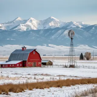 A landscape with a red barn in the foreground at large scale